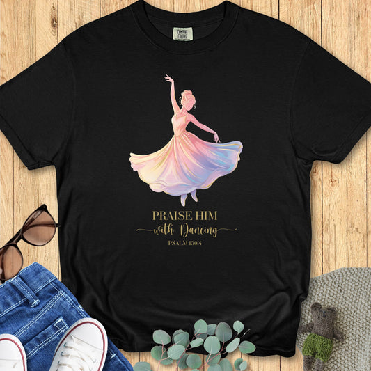 Comfort Colors 1717 Christian women t-shirt in black flat lay. Faith-based design features a pastel dancer illustration and scripture “Praise Him with Dancing – Psalm 150:4