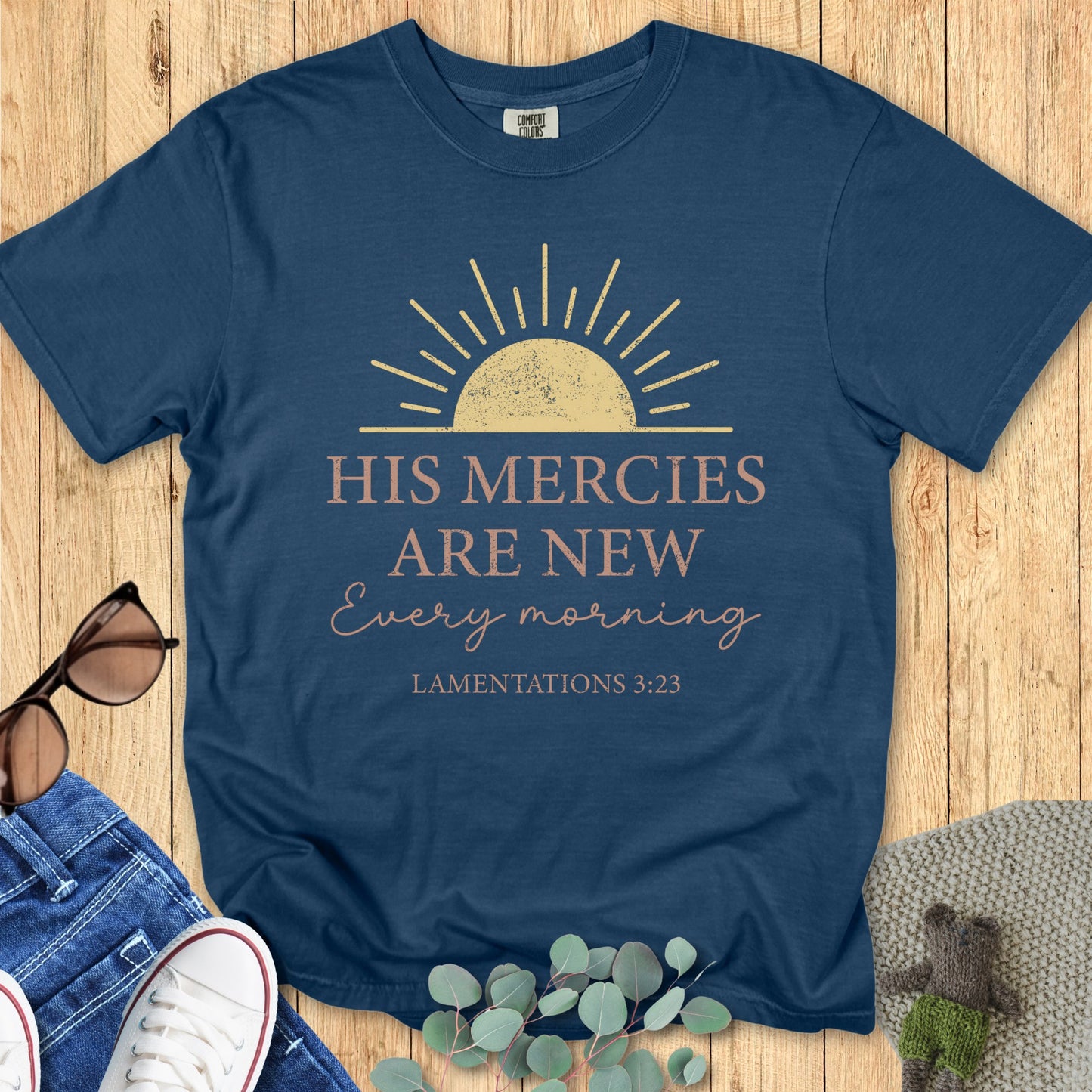Comfort Colors 1717 midnight navy “His Mercies Are New Every Morning – Lamentations 3:23” t-shirt styled flatlay on wood background. A cozy, timeless choice from modern Christian shirts collection.