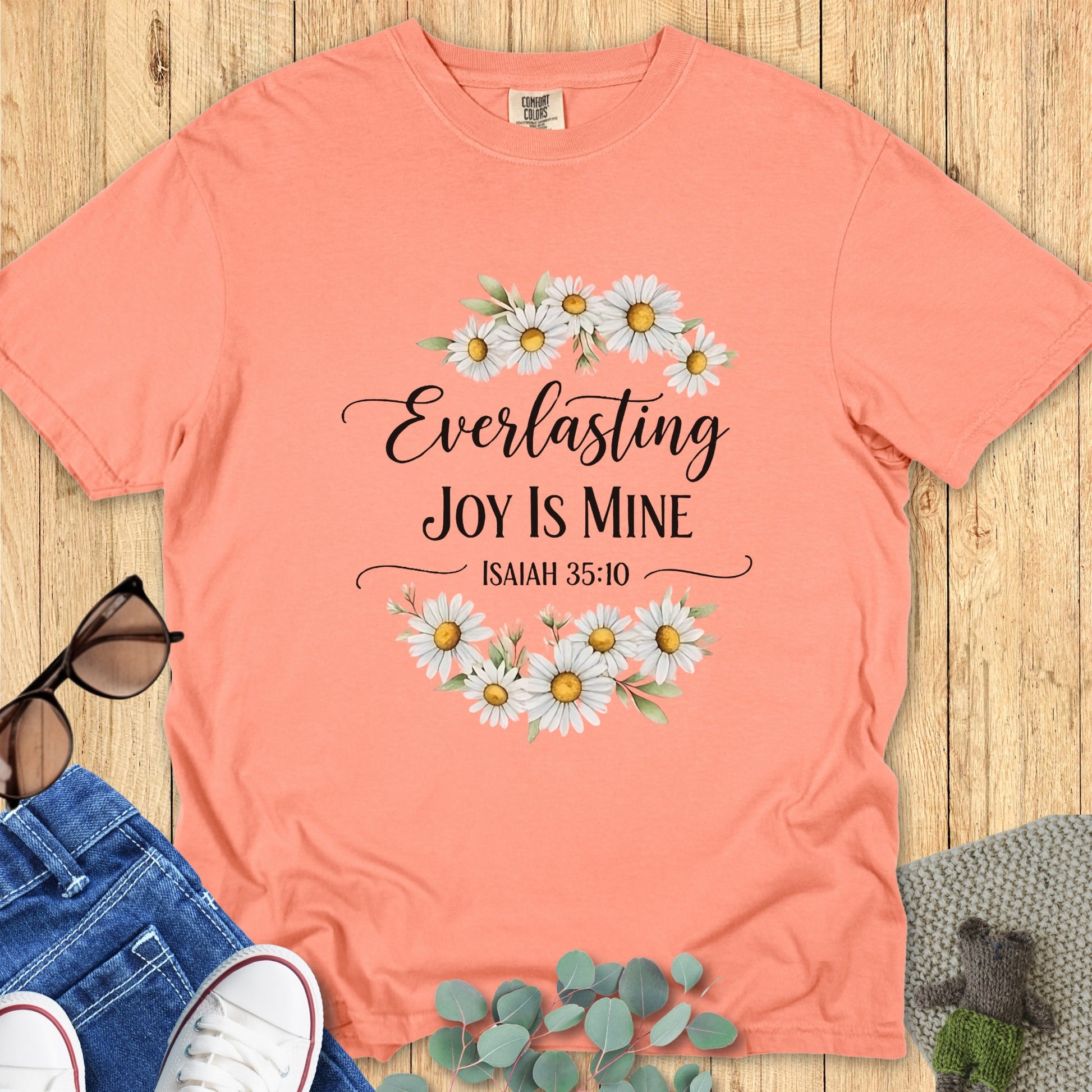 Comfort Colors 1717 terracotta “Everlasting Joy Is Mine – Isaiah 35:10” t-shirt styled with jeans and sunglasses. A warm, faith-based apparel for women piece celebrating joy and gratitude from Isaiah 35:10 t-shirt verse.