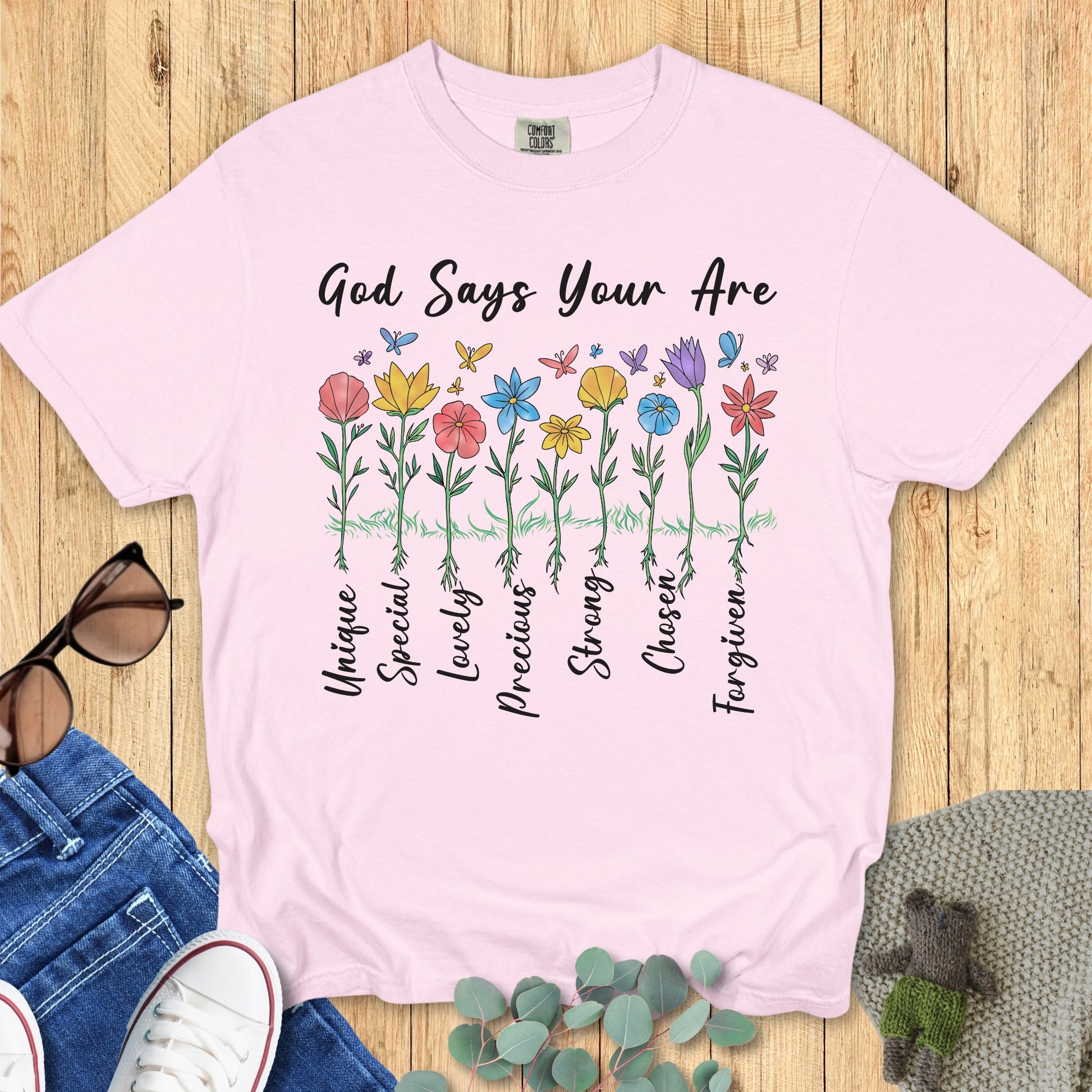 Comfort Colors 1717 blossom “God Says You Are” t-shirt with hand-drawn floral design representing God’s affirmations — Unique, Special, Lovely, Precious, Strong, Chosen, Forgiven. A beautiful modern Christian shirt perfect for women’s scripture tees and Christian mom gift ideas.