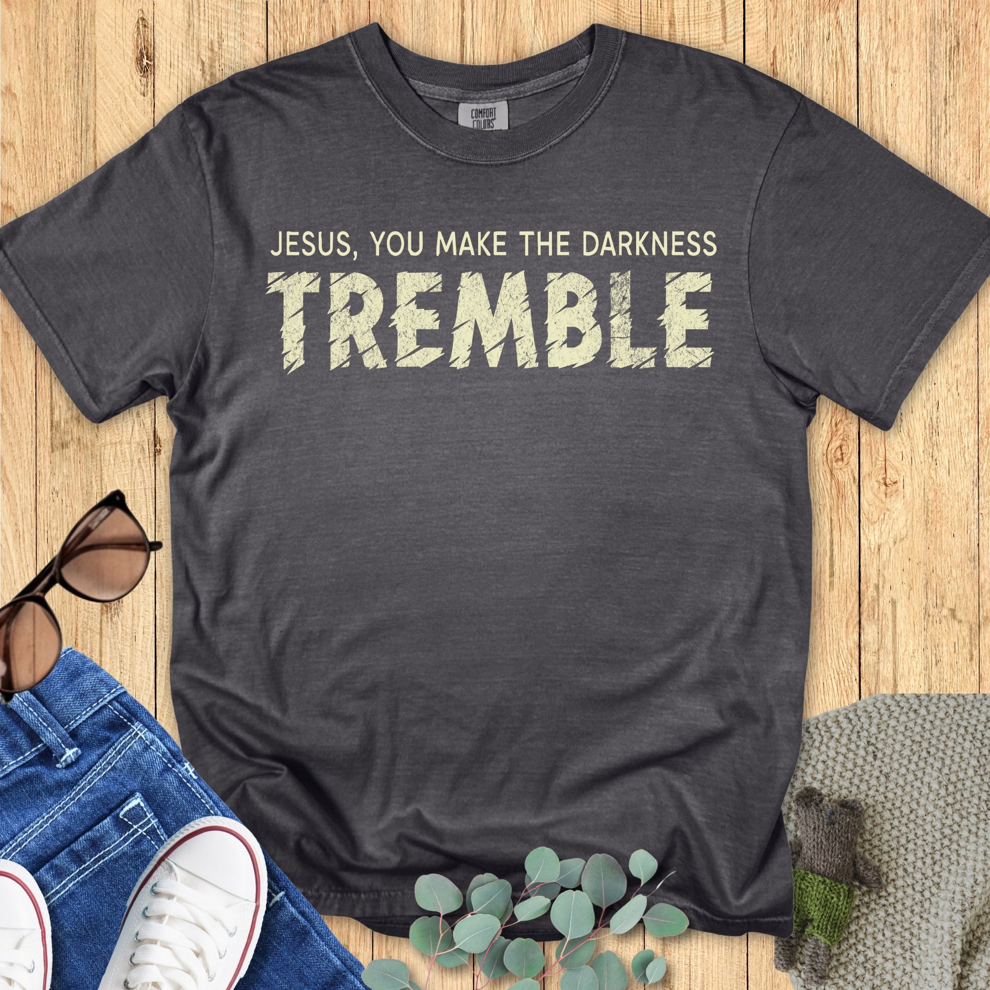 Comfort Colors 1717 pepper “Jesus, You Make the Darkness Tremble” t-shirt with rugged lettering on a soft vintage-style background. A strong women’s scripture tee — expressive faith-based apparel for women and trendy modern Christian shirt, perfect Christian mom gift idea.