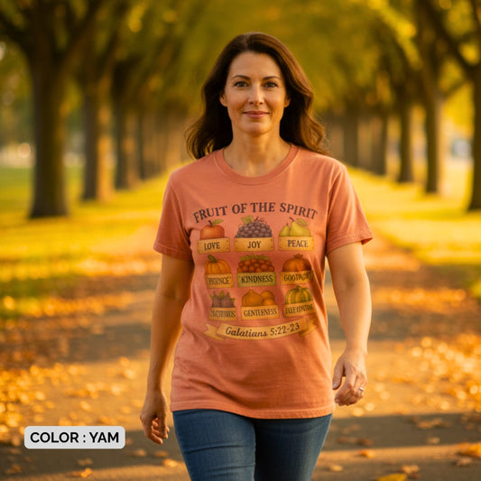 Woman walking outdoors in autumn wearing a Comfort Colors 1717 yam “Fruit of the Spirit” t-shirt printed with Galatians 5:22–23. A warm, seasonal women’s scripture tee — faith-based apparel for women and modern Christian shirt, perfect Christian mom gift idea for fall.
