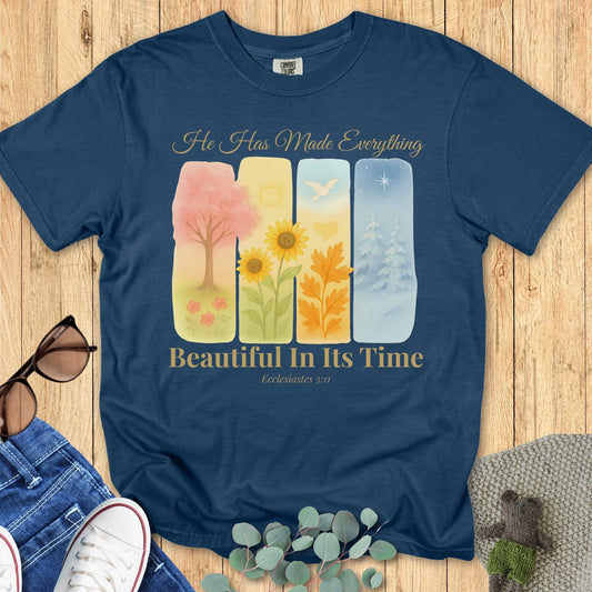 Flatlay of a Comfort Colors 1717 midnight “He Has Made Everything Beautiful in Its Time – Ecclesiastes 3:11” t-shirt featuring floral and nature-inspired art. A stylish women’s scripture tee ideal for everyday faith wear.