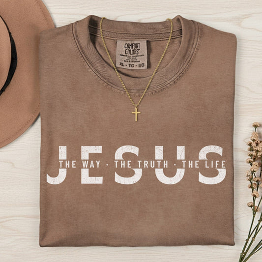 Comfort Colors 1717 espresso “Jesus — The Way, The Truth, The Life” t-shirt paired with a gold cross necklace. A vintage-style women’s scripture tee — faith-based apparel for women and modern Christian shirt featuring John 14:6, beautiful Christian mom gift idea.