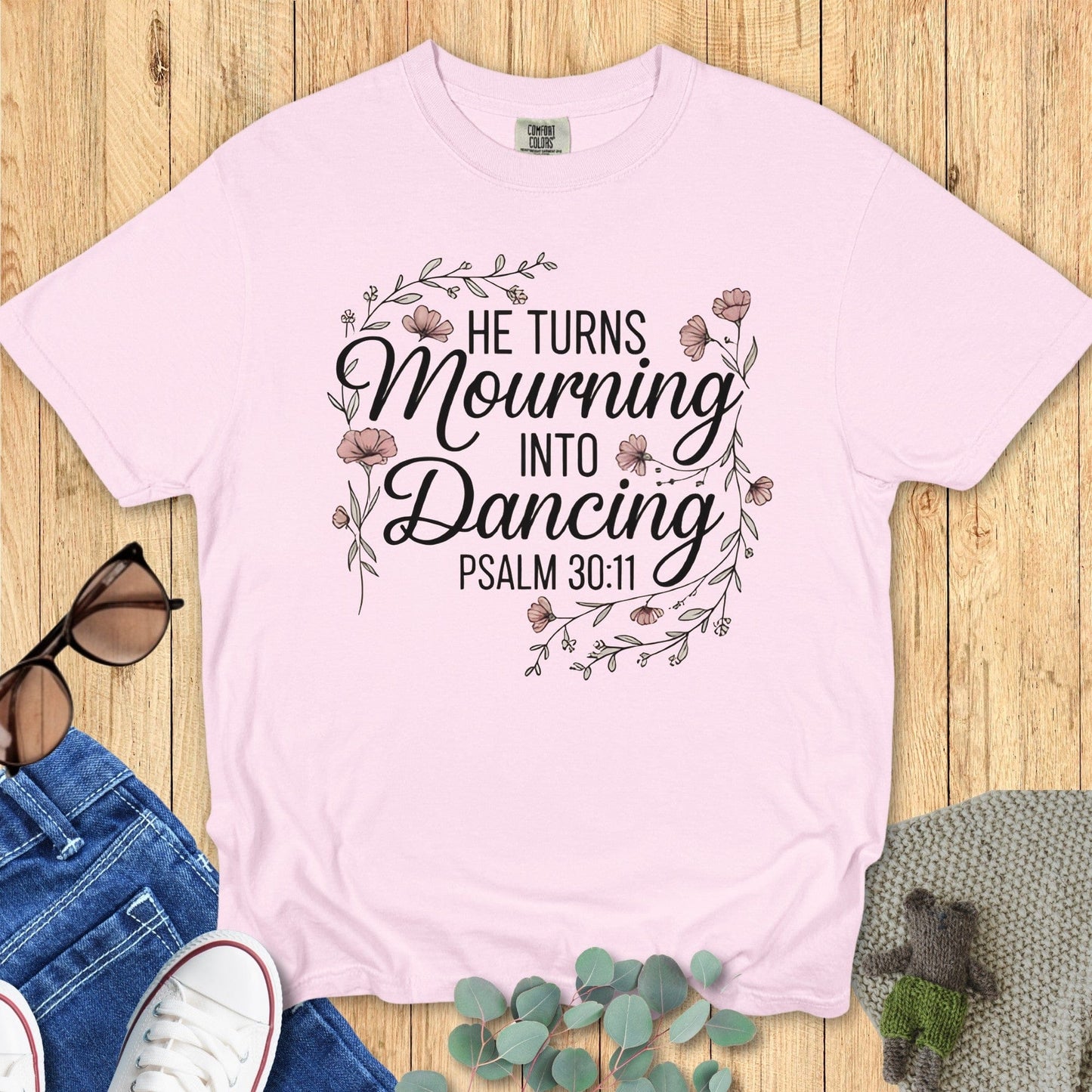 Comfort Colors 1717 blossom “He Turns Mourning Into Dancing – Psalm 30:11” t-shirt with elegant floral wreath design. A joyful modern Christian shirt reminding women of God’s renewal — ideal for women’s scripture tees and Christian mom gift ideas.