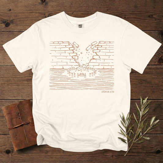 Comfort Colors 1717 ivory Christian women tee showcasing a minimalist wall-of-Jericho artwork based on Joshua 6:20, drawn in warm line-art. A stylish scripture-rooted T-shirt for US faith wear, perfect for Christian women who enjoy subtle Bible-story designs.