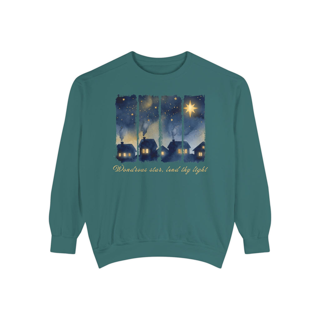 Blue Spruce Christian Christmas sweatshirt with a painted village at night, glowing windows, a big golden star and Wondrous star, lend thy light in script.