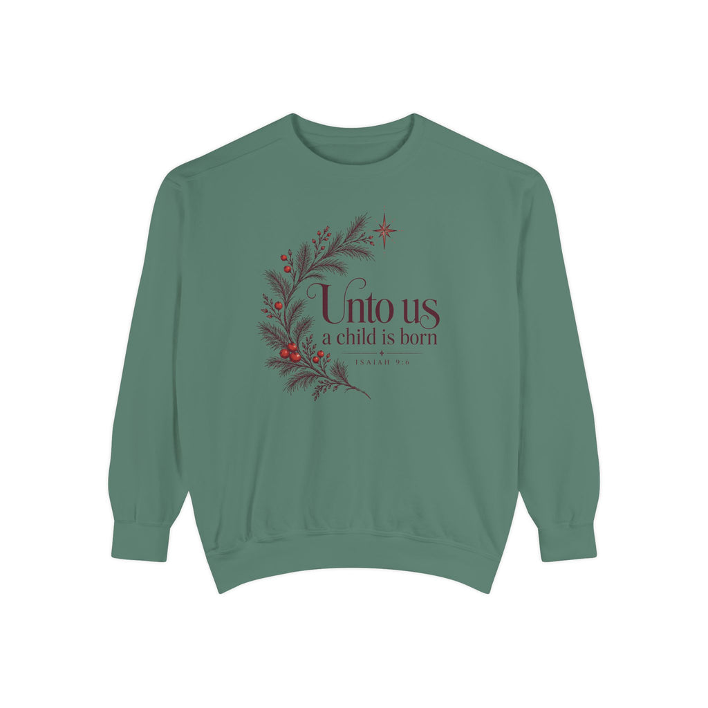 Christian Christmas sweatshirt with Unto Us a Child Is Born lettering, evergreen branches, red berries, a star and Isaiah 9:6.