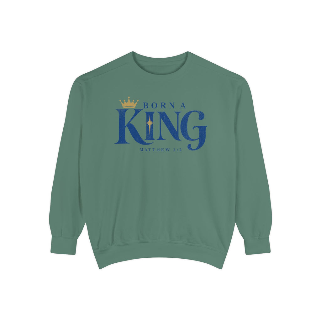 Light Green Christian Christmas sweatshirt with Born a King lettering, a crown, a star and Matthew 2:2.