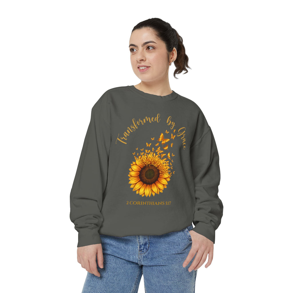 Christian sweatshirt with a painted sunflower whose petals turn into butterflies, reading Transformed by Grace, 2 Corinthians 5:17
