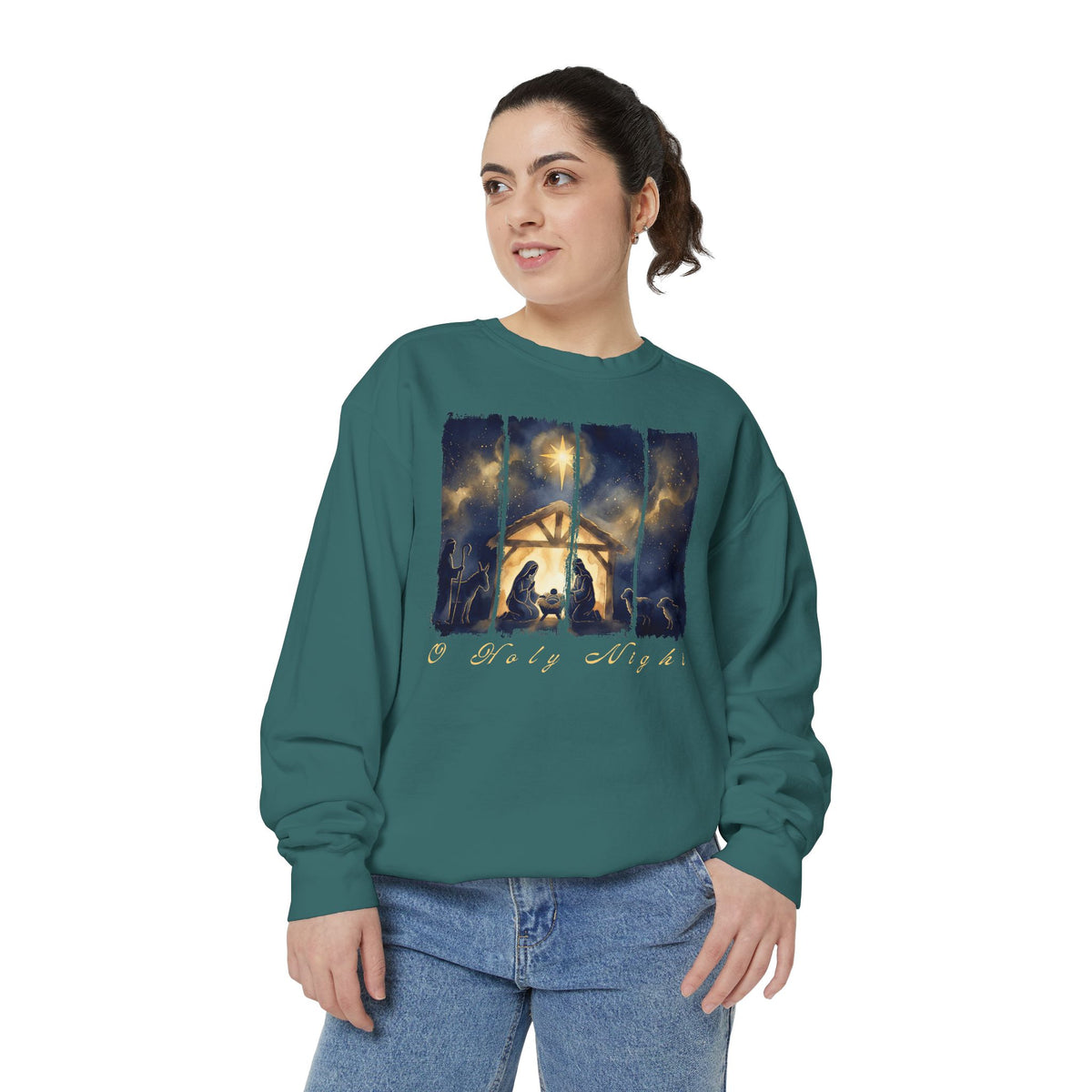 Christian Christmas sweatshirt with a painted nativity of Mary, Joseph and the manger in a glowing stable under a bright star, with O Holy Night in script.