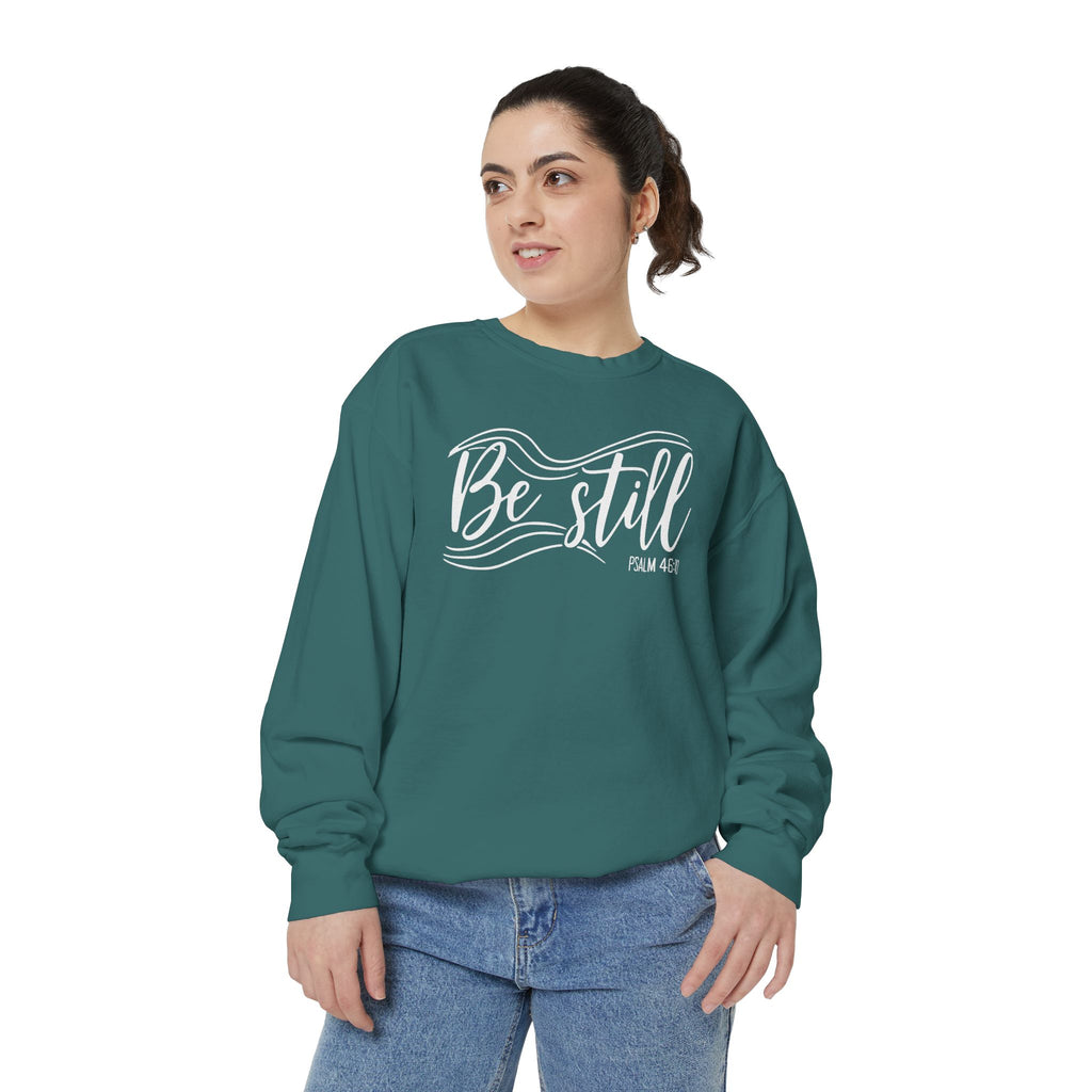 Christian sweatshirt reading Be still in flowing brush script with sweeping lines, Psalm 46:10