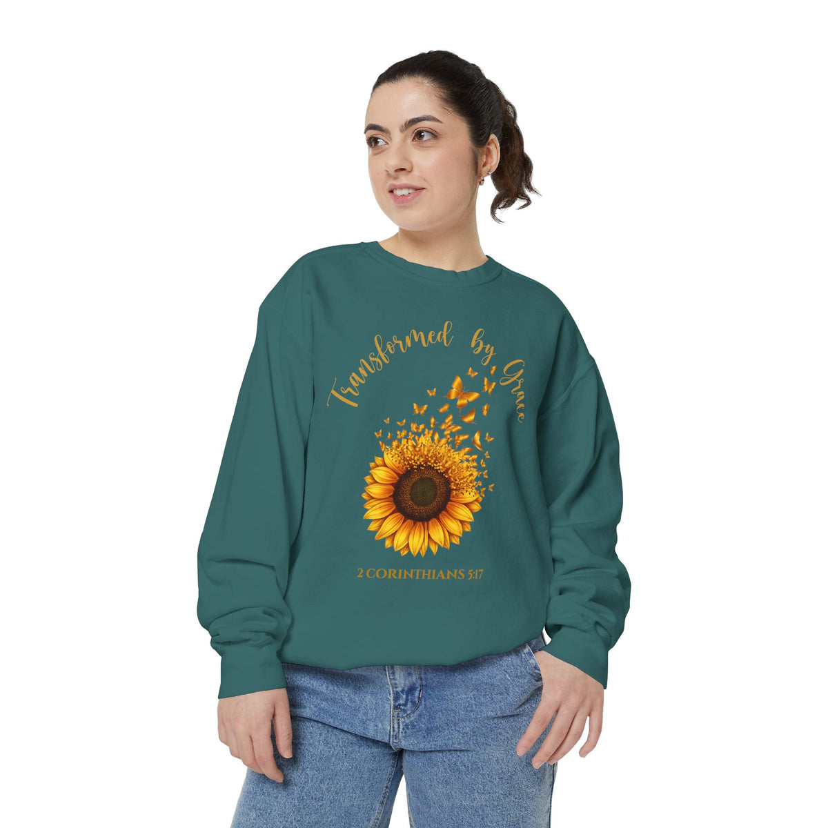 Christian sweatshirt with a painted sunflower whose petals turn into butterflies, reading Transformed by Grace, 2 Corinthians 5:17