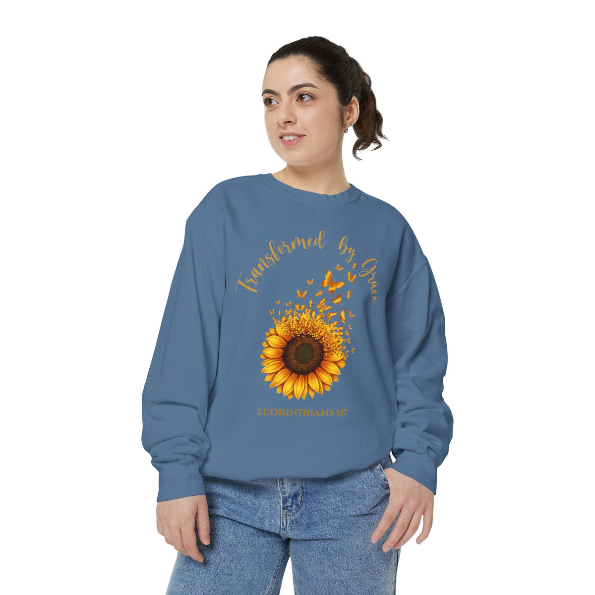 Christian sweatshirt with a painted sunflower whose petals turn into butterflies, reading Transformed by Grace, 2 Corinthians 5:17