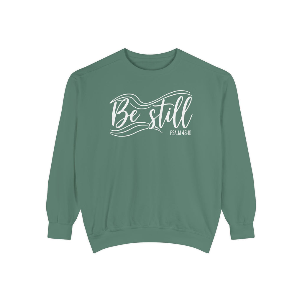 Light Green Christian sweatshirt reading Be still in flowing brush script with sweeping lines, Psalm 46:10