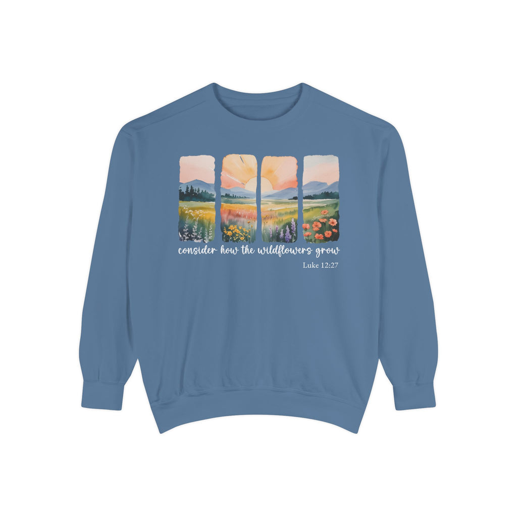 Blue Jean Christian sweatshirt with four painted panels of sunrise over hills and a wildflower meadow, reading consider how the wildflowers grow, Luke 12:27