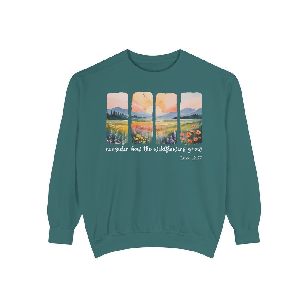 Blue Spruce Christian sweatshirt with four painted panels of sunrise over hills and a wildflower meadow, reading consider how the wildflowers grow, Luke 12:27