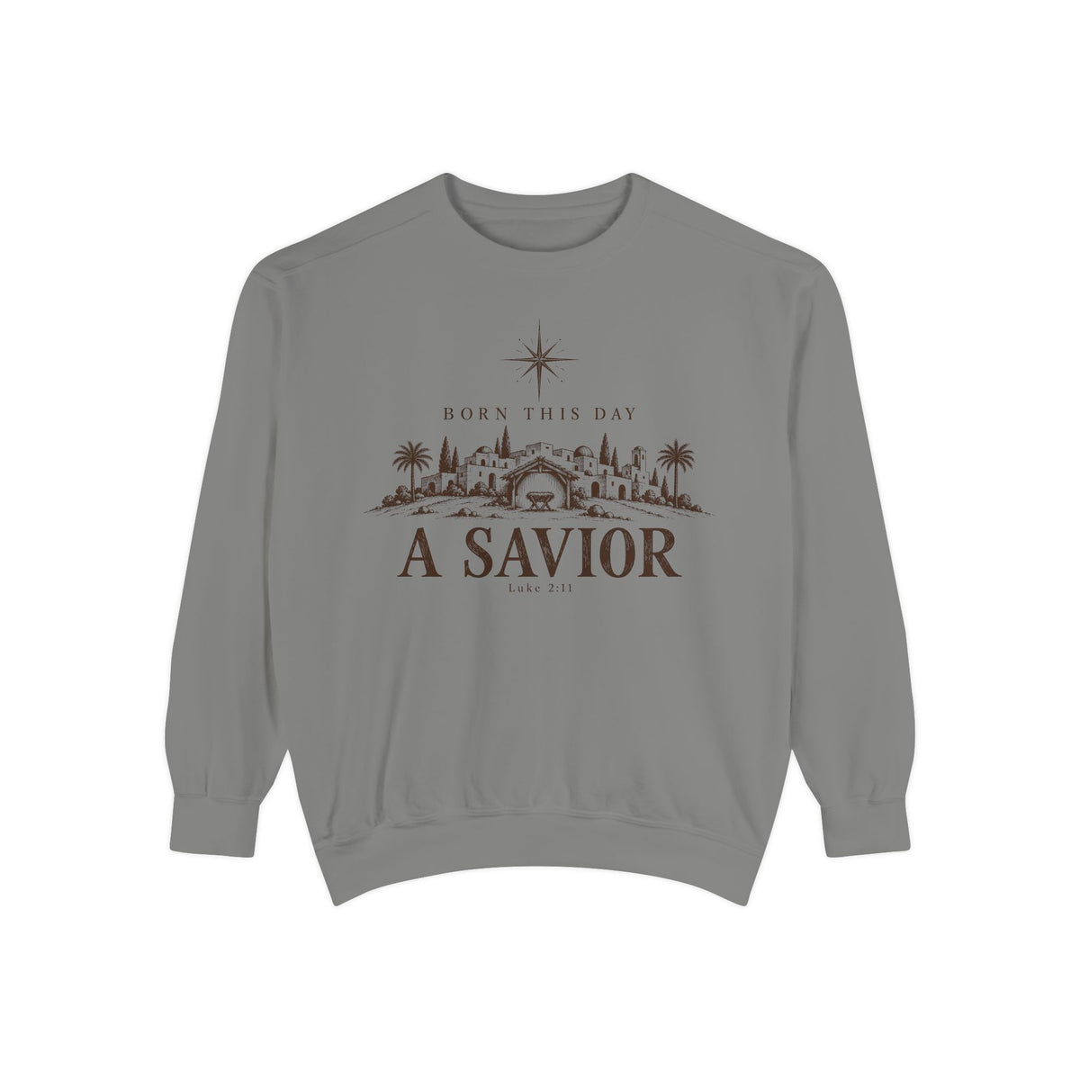 Grey Christian Christmas sweatshirt with Born This Day A Savior lettering, a star over a Bethlehem town scene, a manger and Luke 2:11.