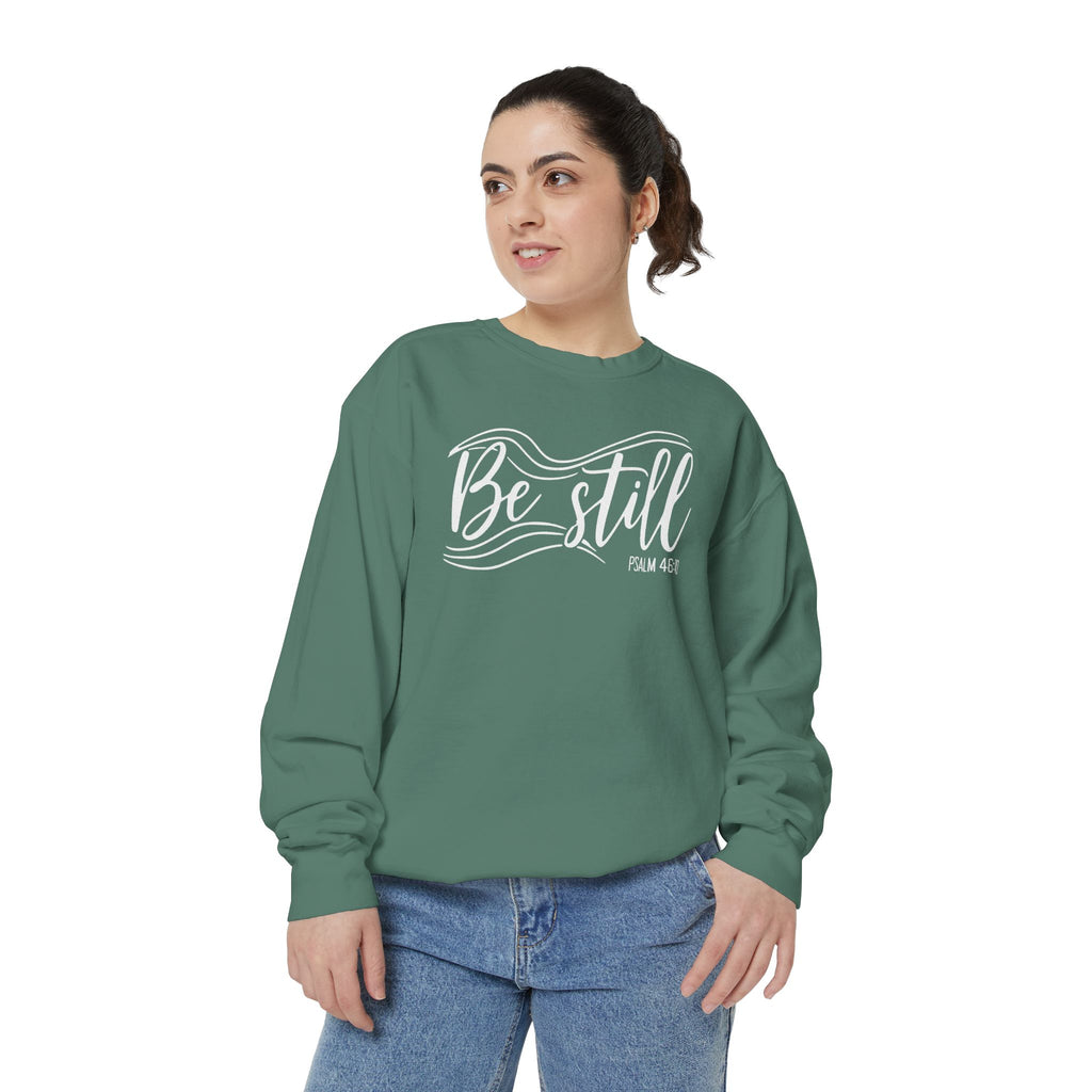 Christian sweatshirt reading Be still in flowing brush script with sweeping lines, Psalm 46:10