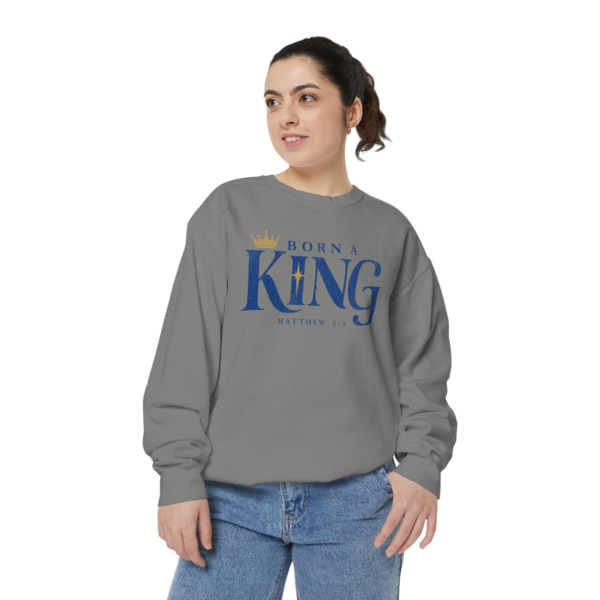 Christian Christmas sweatshirt with Born a King lettering, a crown, a star and Matthew 2:2.
