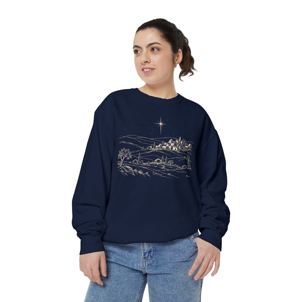 Christian Christmas sweatshirt with line art of Bethlehem on a hillside, a radiant star, an open stable and Micah 5:2.