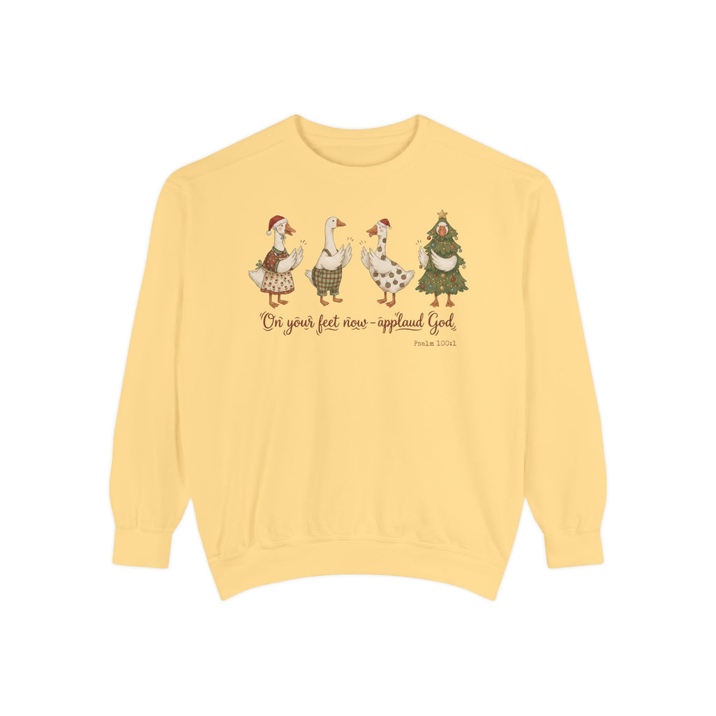 Butter Christian Christmas sweatshirt with four geese in Santa hats and Christmas outfits clapping above On your feet now, applaud God and Psalm 100:1.