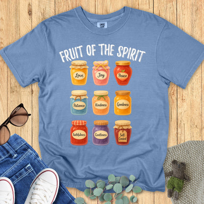 Comfort Colors 1717 Christian women t-shirt in blue jean flat lay. Faith-based Fruit of the Spirit design featuring nine illustrated jars with words like Love, Joy, Peace, and Kindnes