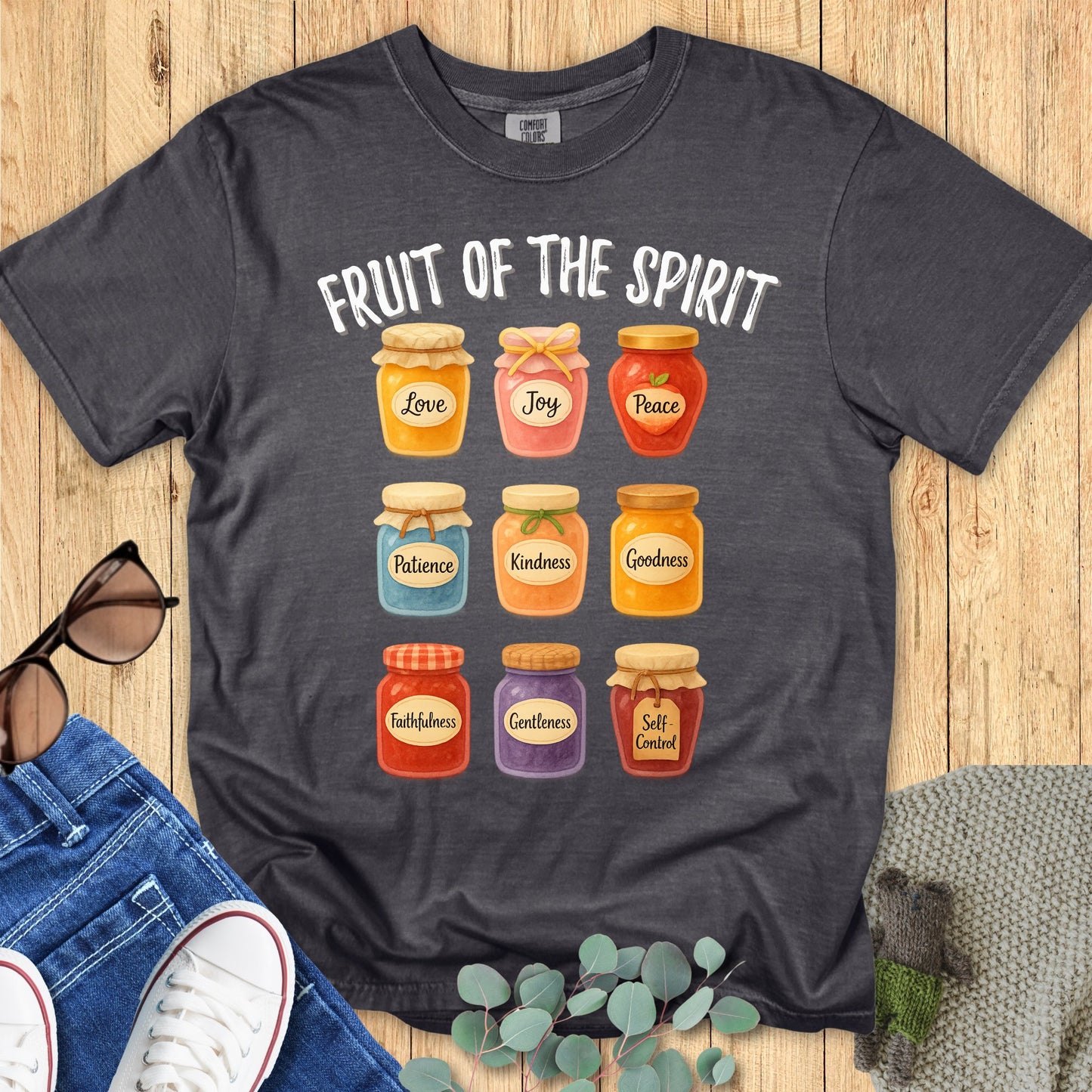 Comfort Colors 1717 Christian women t-shirt in pepper gray flat lay. Christian design shows colorful jars labeled with Fruit of the Spirit virtues from Galatians 5:22-23