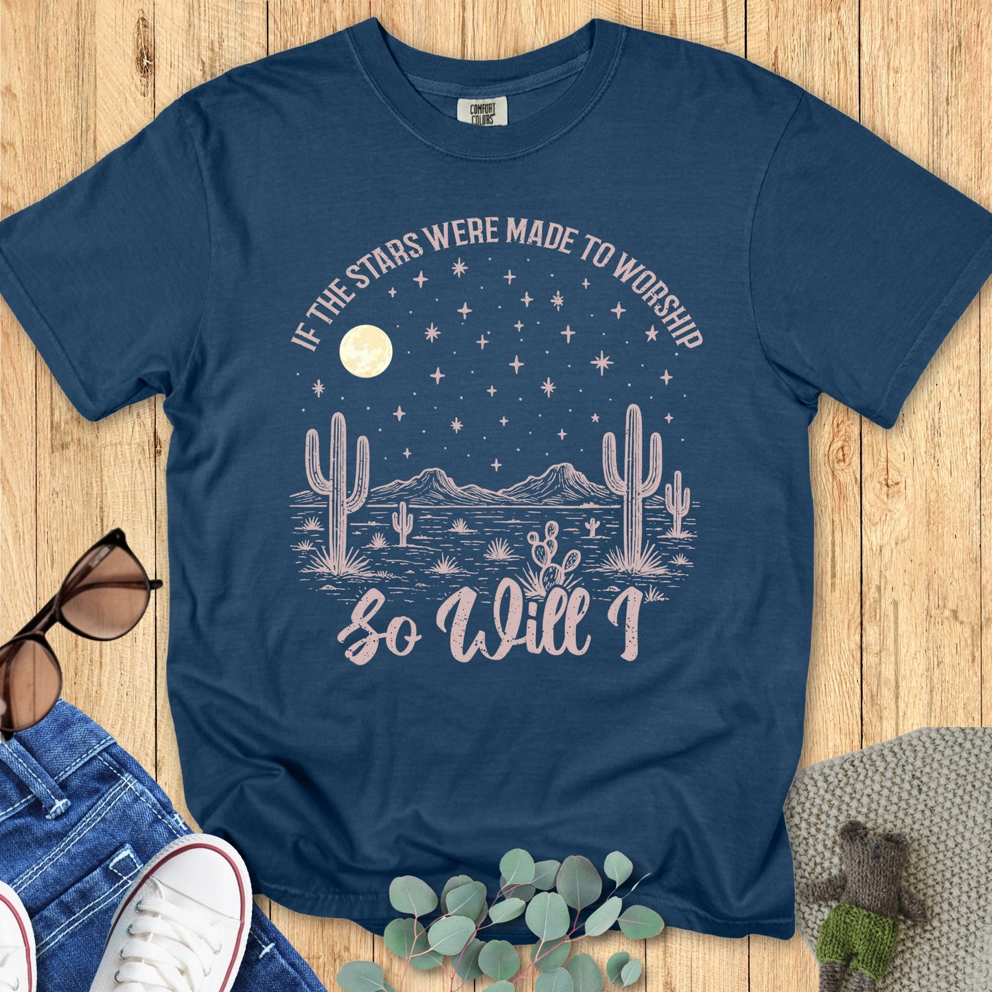 Christian women’s t-shirt on Comfort Colors 1717 in midnight blue with desert cactus design under a starry sky, moon, and the words 'If the stars were made to worship so will I.