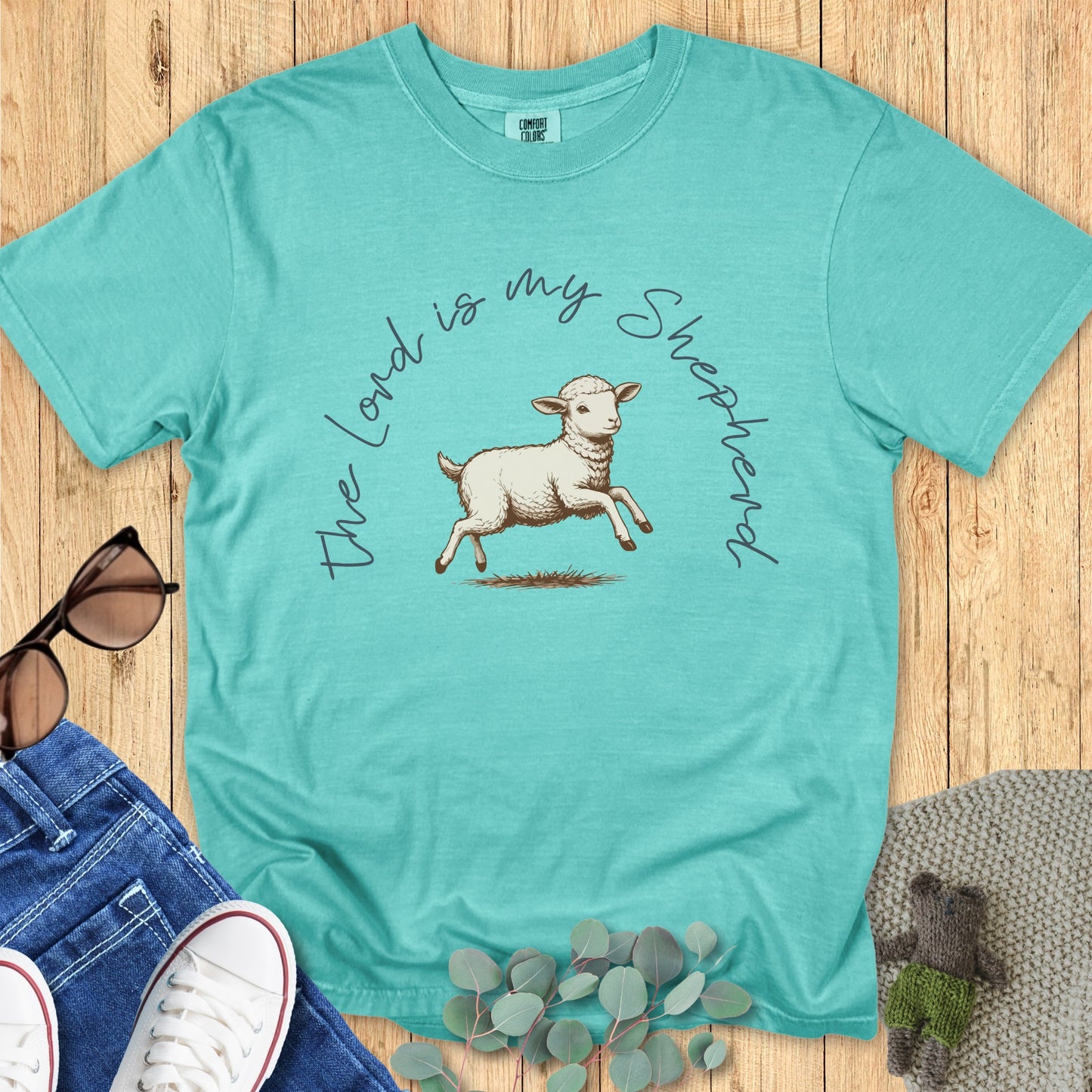 Comfort Colors 1717 seafoam “The Lord Is My Shepherd” t-shirt with a vintage lamb illustration. A modern Christian shirt for women that blends rustic charm with comforting scripture.
