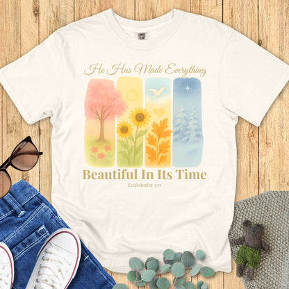 Comfort Colors 1717 ivory “He Has Made Everything Beautiful in Its Time – Ecclesiastes 3:11” t-shirt with pastel seasonal artwork symbolizing God’s perfect timing. A modern Christian shirt and thoughtful Christian mom gift idea.