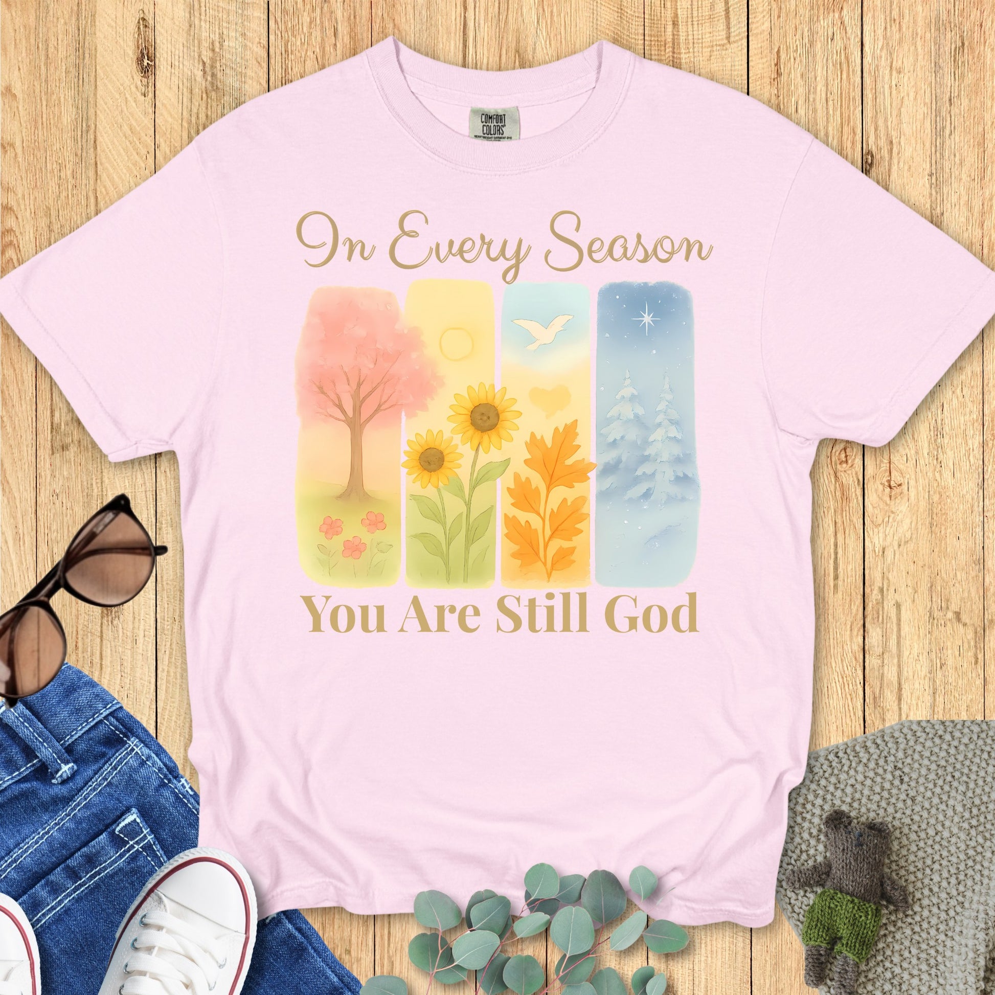 Comfort Colors 1717 blossom “In Every Season You Are Still God” t-shirt with pastel seasonal illustrations representing spring, summer, fall, and winter. A stylish modern Christian shirt and thoughtful Christian mom gift idea.