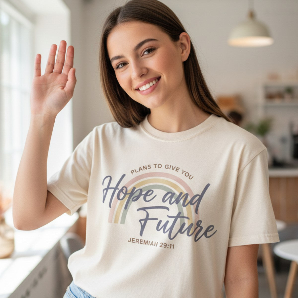 Smiling woman wearing a Comfort Colors 1717 ivory “Hope and Future – Jeremiah 29:11” t-shirt with pastel rainbow design. A cheerful and uplifting women’s scripture tee — modern Christian shirt and meaningful faith-based gift for moms or women of faith.