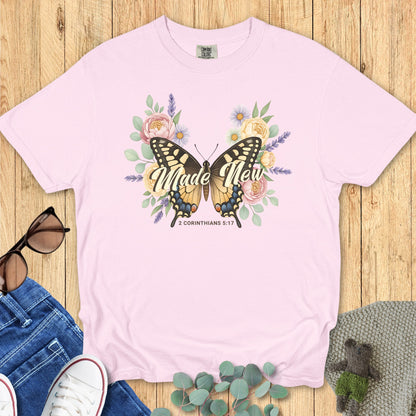 Comfort Colors 1717 blossom “Made New – 2 Corinthians 5:17” t-shirt with butterfly and pastel flower design symbolizing new life. A soft and feminine women’s scripture tee — inspiring faith-based apparel for women and thoughtful Christian mom gift.