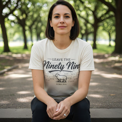 Woman sitting outdoors wearing a Comfort Colors 1717 ivory “Leave the Ninety-Nine – Luke 15:4” t-shirt featuring a shepherd and sheep design. A soft and meaningful women’s scripture tee — faith-based apparel for women and modern Christian shirt, perfect Christian mom gift idea.