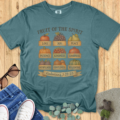 Flatlay of a Comfort Colors 1717 blue spruce “Fruit of the Spirit” t-shirt with warm autumn-inspired fruit design representing love, joy, peace, patience, kindness, and more from Galatians 5:22–23. A stylish women’s scripture tee — faith-based apparel for women and modern Christian shirt, ideal Christian mom gift idea.