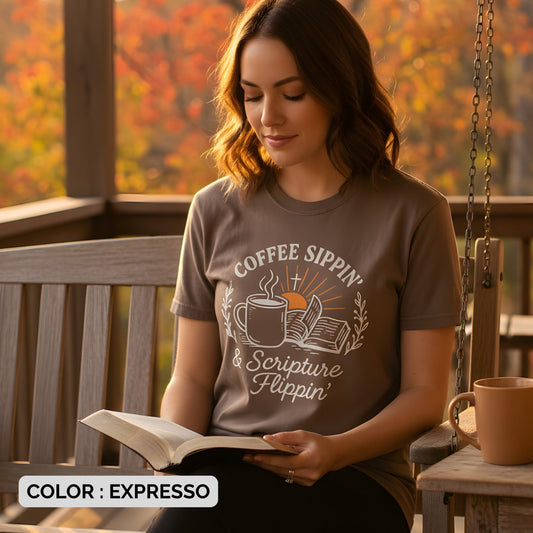 Woman sitting on a porch swing reading her Bible while wearing a Comfort Colors 1717 brown “Coffee Sippin’ & Scripture Flippin’” t-shirt. A cozy women’s scripture tee -  faith-based apparel for women and modern Christian shirt, perfect Christian mom gift idea for quiet morning devotion time.