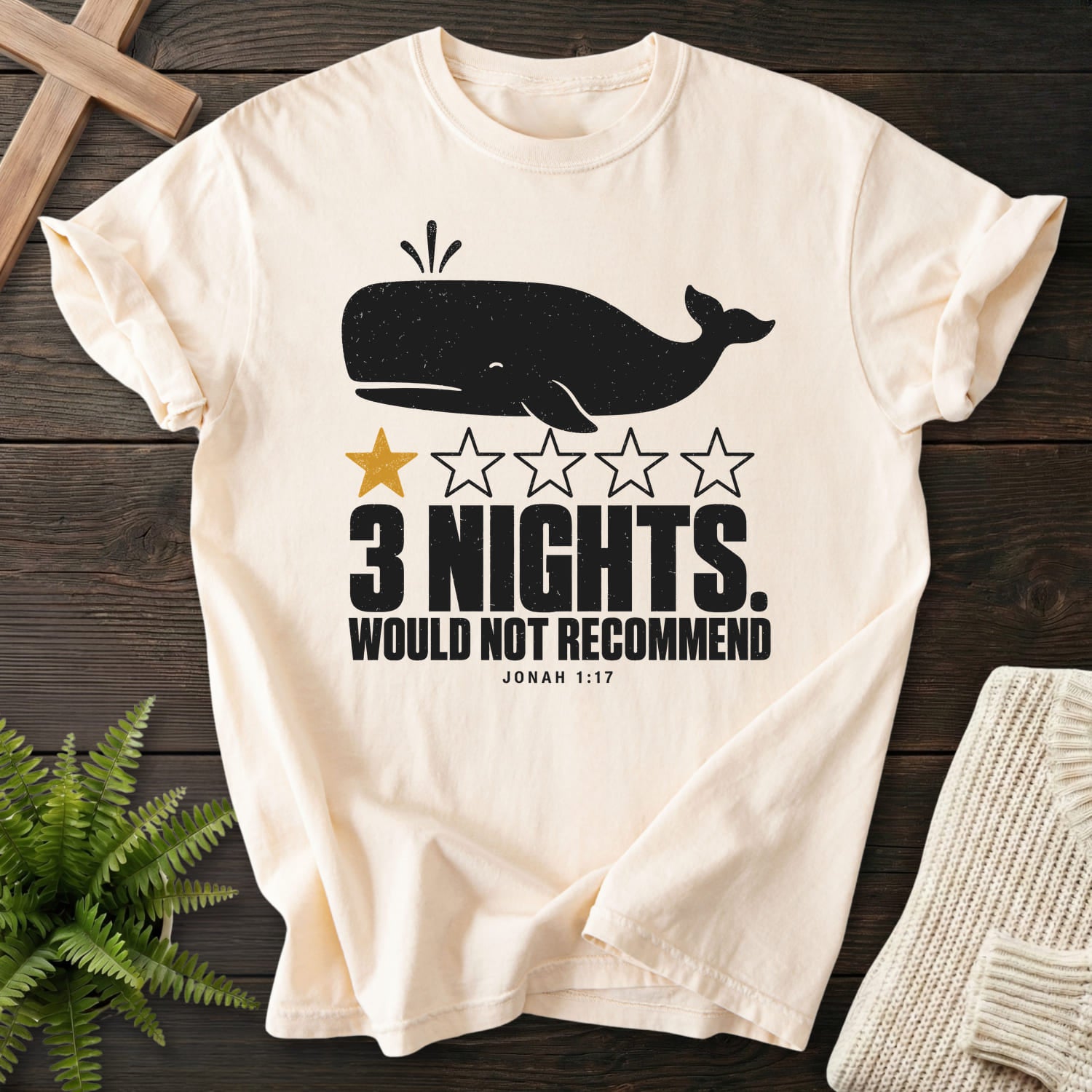 Flat lay of an Ivory Comfort Colors 1717 Christian shirt featuring minimal whale artwork with "3 Nights Jonah 1 17 Dark T-Shirt".