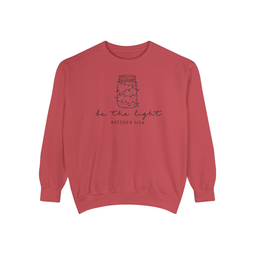 Crimson Christian Christmas sweatshirt with a mason jar wrapped in Christmas lights, be the light script and Matthew 5:14.