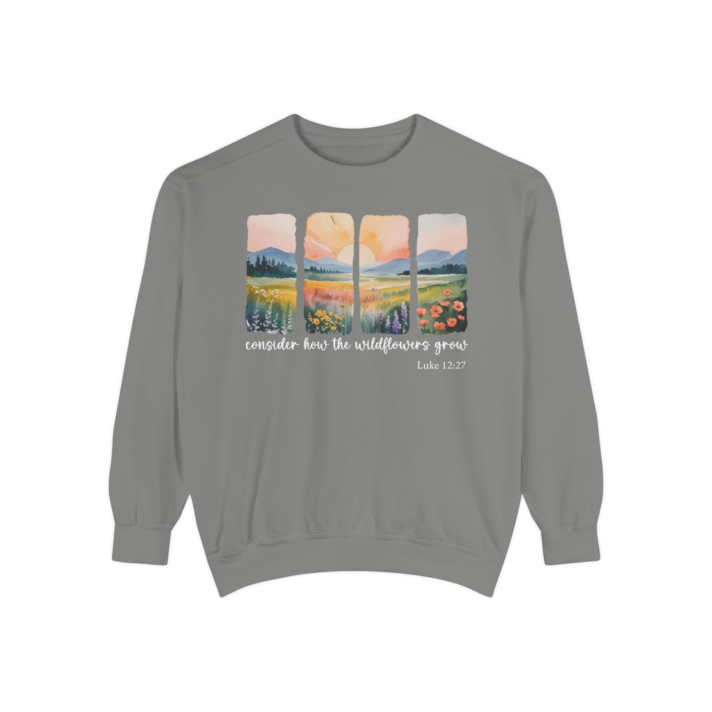 Grey Christian sweatshirt with four painted panels of sunrise over hills and a wildflower meadow, reading consider how the wildflowers grow, Luke 12:27