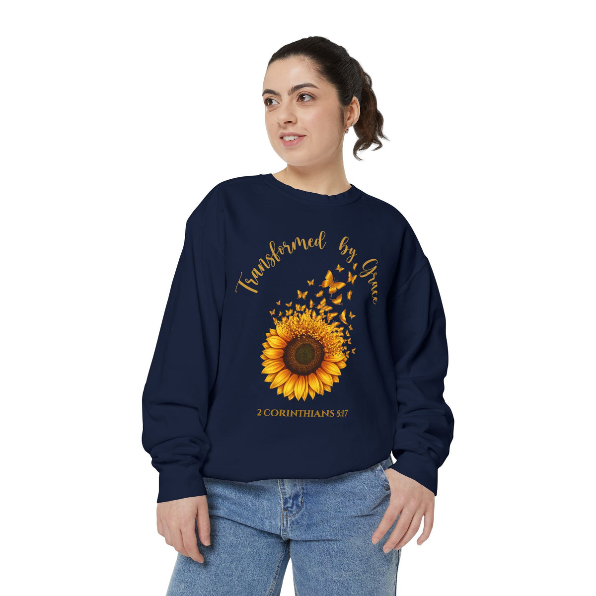Christian sweatshirt with a painted sunflower whose petals turn into butterflies, reading Transformed by Grace, 2 Corinthians 5:17