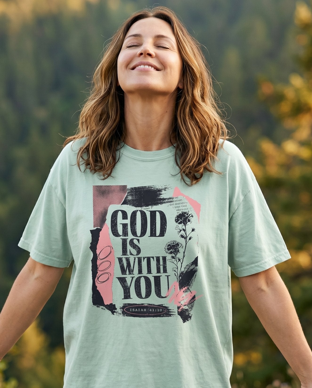 God Is With You – Bay women's Christian tee, lifestyle photo in nature trail – God Is With You encouragement walk journey faith lettering – She Wears Faith