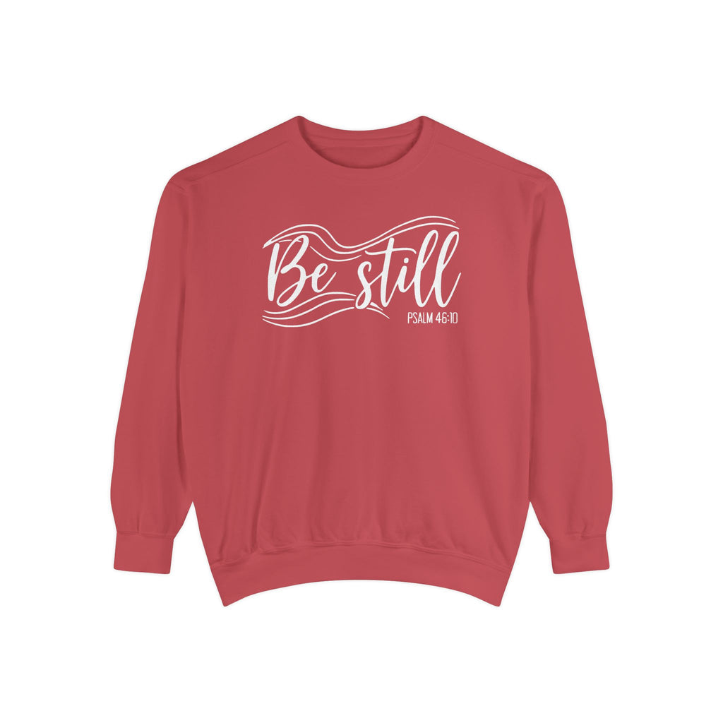 Crimson Christian sweatshirt reading Be still in flowing brush script with sweeping lines, Psalm 46:10