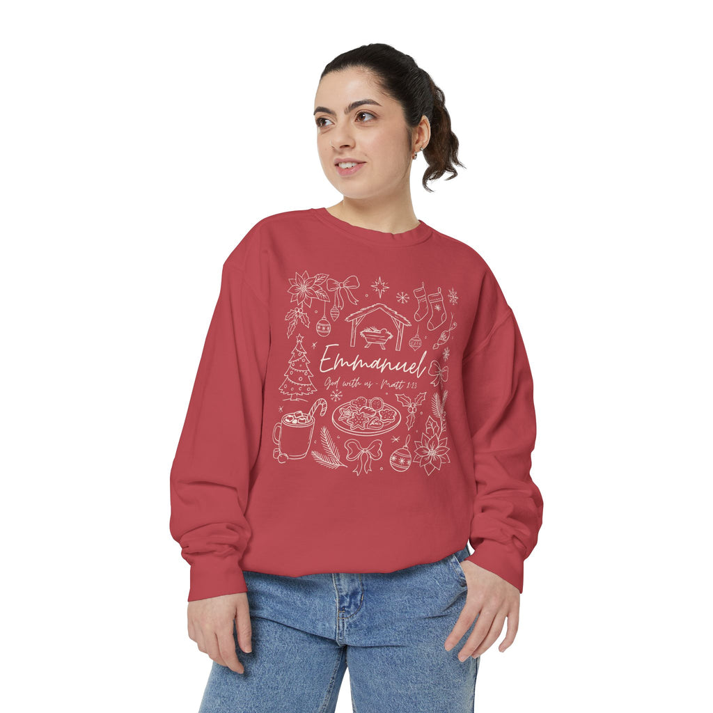 Christian Christmas sweatshirt with Emmanuel God with us script and Matthew 1:23 surrounded by doodles of a manger, stockings, a tree, cocoa and cookies.