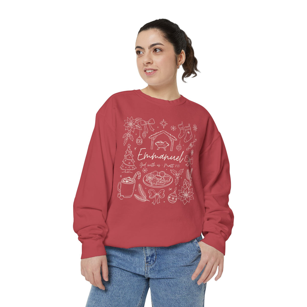 Christian Christmas sweatshirt with Emmanuel God with us script and Matthew 1:23 surrounded by doodles of a manger, stockings, a tree, cocoa and cookies.