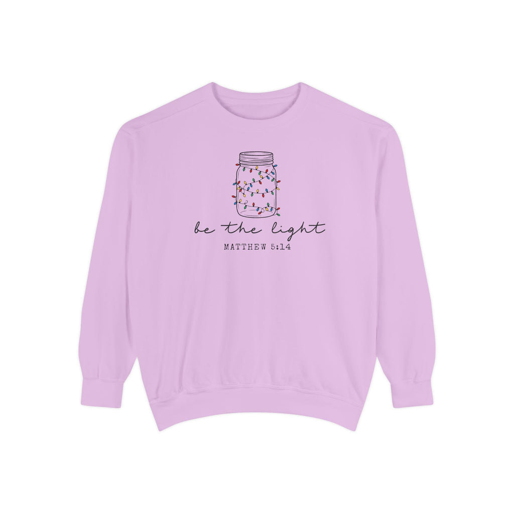 Orchid Christian Christmas sweatshirt with a mason jar wrapped in Christmas lights, be the light script and Matthew 5:14.