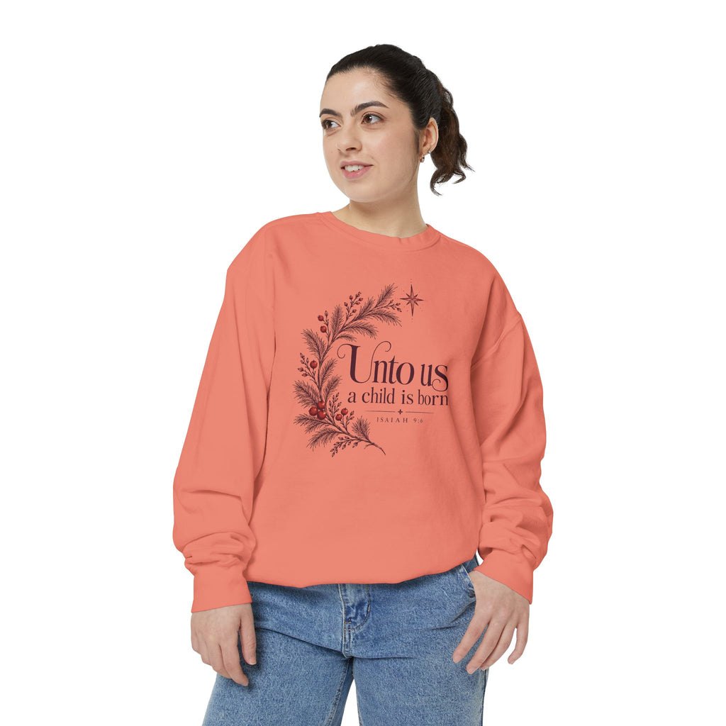 Christian Christmas sweatshirt with Unto Us a Child Is Born lettering, evergreen branches, red berries, a star and Isaiah 9:6.