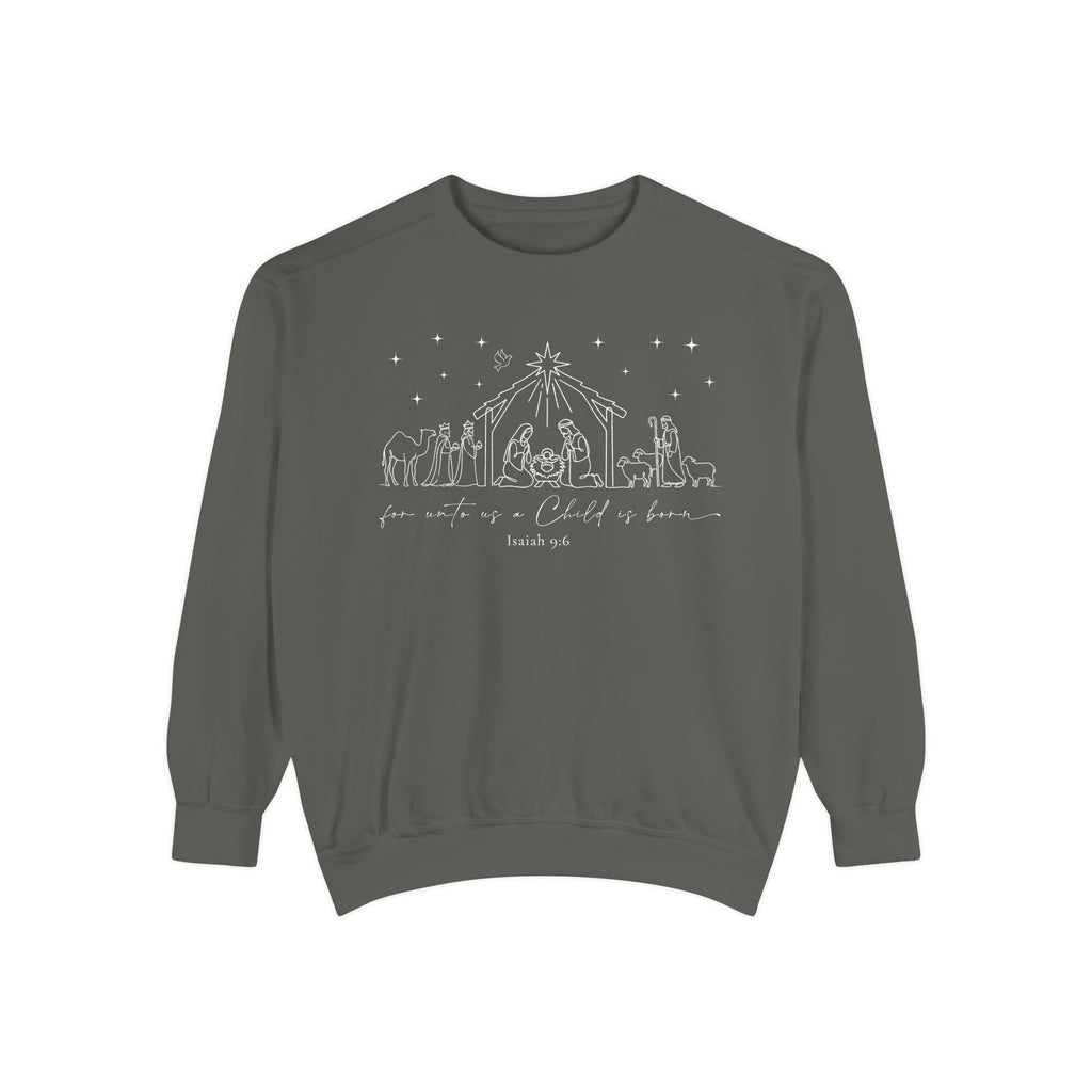 Pepper Christian Christmas sweatshirt with nativity line art of Mary, Joseph, the manger, wise men, a shepherd and sheep, for unto us a Child is born and Isaiah 9:6.