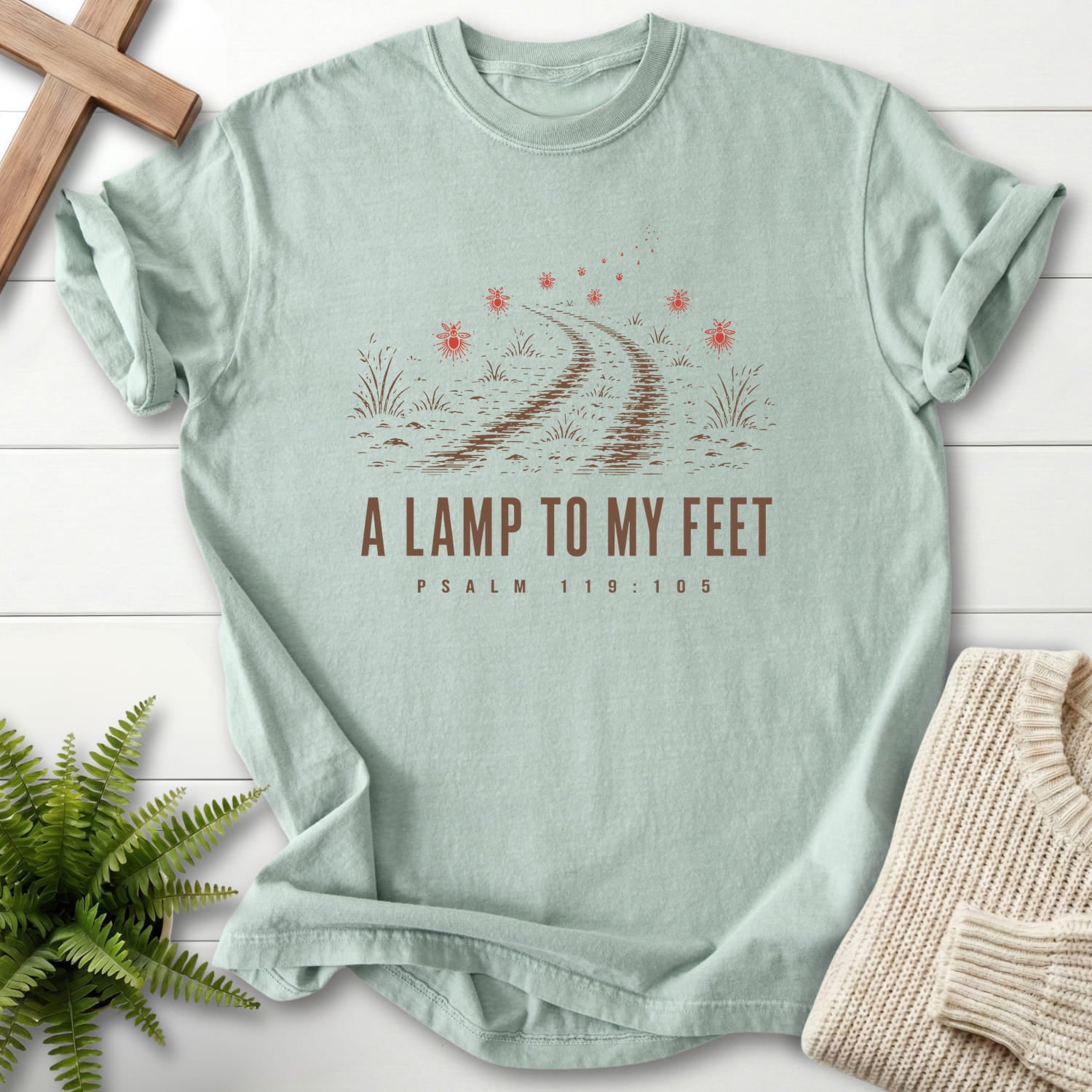 Flat lay of a Bay faith-inspired shirt featuring "A Lamp to my Feet T-Shirt" design.