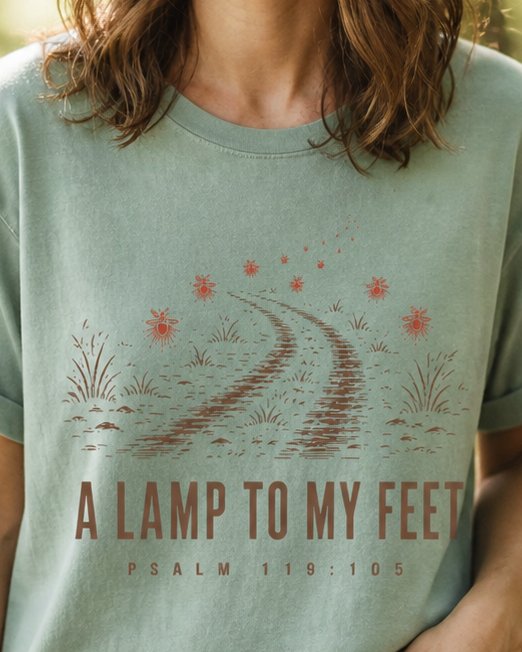 A Lamp to my Feet - Bay women's Christian tee, lifestyle photo in nature trail - Winding night path lit by glowing fireflies - Psalm 119:105 - She Wears Faith